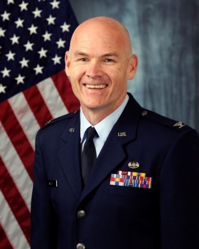 Charlie Wiedie, 2026 Anthony Wayne Hall of Fame inductee, smiling in his U.S. Air Force dress uniform with an American flag behind him.